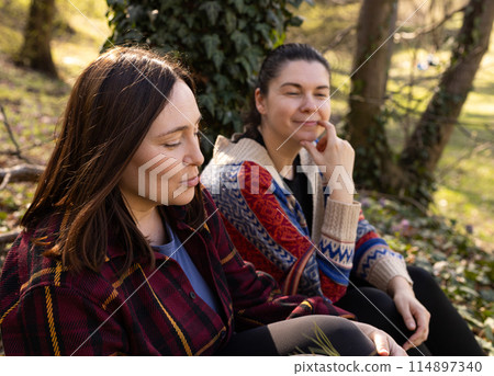 two young women in the forest, tourism, enjoying nature two young women in the forest, tourism, enjoying nature 114897340