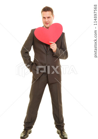 Flirting man in suit holding heart love symbol Flirting man in suit holding heart love symbol 114897568