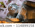 Nirvana white marble reclining Buddha, beautiful flower background. 114899158