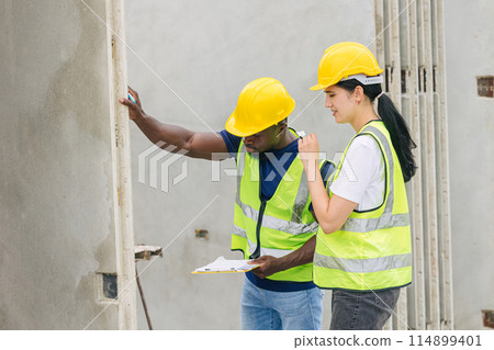 Engineer smart women working contact with African black worker in Precast concrete casting manufacturing company site inspector Engineer smart women working contact with African black worker in Precast concrete casting manufacturing company site inspector 114899401
