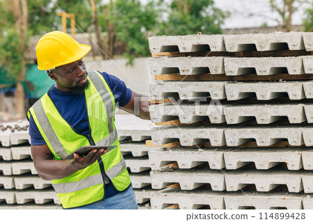 African black engineer worker working in Precast concrete casting manufacturing checking product quality standard outdoor construction site 114899428