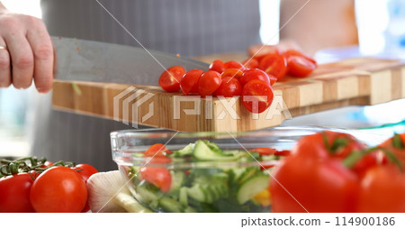 Chef Hands Pouring Cherry Tomato Cucumber Salad 114900186