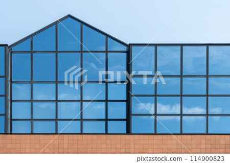 Glass facade reflecting blue sky Glass facade reflecting blue sky 114900823