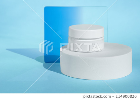 White cosmetic jar on blue background White cosmetic jar on blue background 114900826