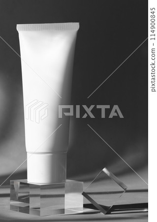 White cosmetic tube on acrylic block 114900845