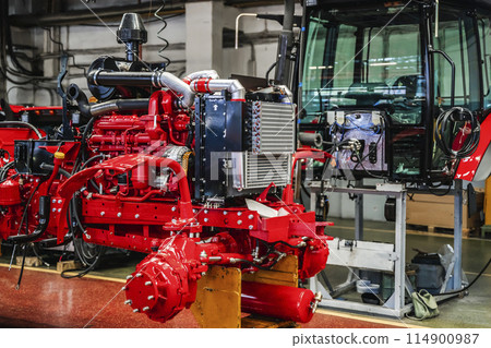 Tractor industry manufacture. New tractors on factory line. Production of agricultural machinery 114900987