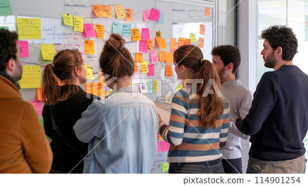 Team has a creative session, using a whiteboard and sticky notes for ideas. Team has a creative session, using a whiteboard and sticky notes for ideas. 114901254