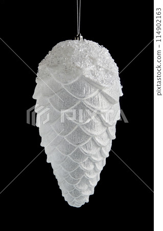 White Christmas tree toy in the shape of a fir cone isolated on a black background 114902163
