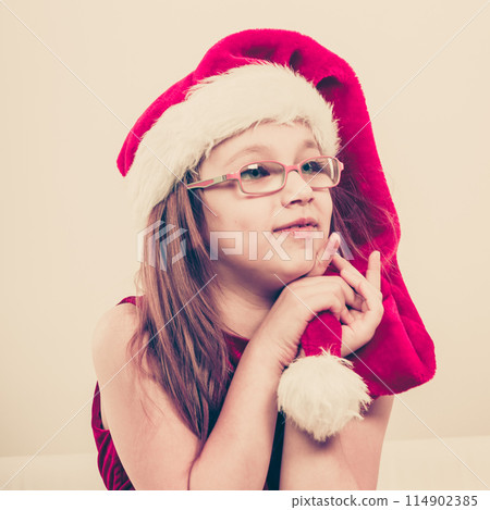 Christmas girl in santa hat festive outfit 114902385