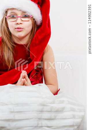 Christmas girl in santa hat folded hand Christmas girl in santa hat folded hand 114902391