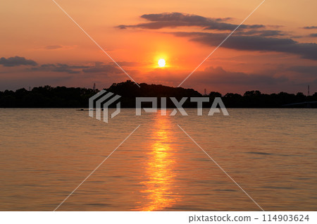 The sun setting over Lake Asahi in Toda City, Saitama Prefecture 114903624