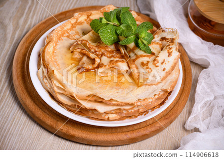 Homemade thin crepe (pancakes) with honey Homemade thin crepe (pancakes) with honey 114906618
