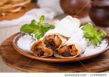 Homemade thin crepe (pancakes) with apple filling 114906620