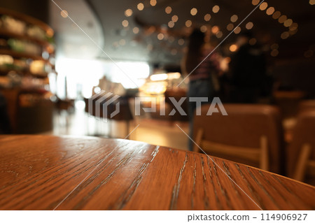 Empty wooden table top with lights bokeh on blur restaurant background Empty wooden table top with lights bokeh on blur restaurant background 114906927