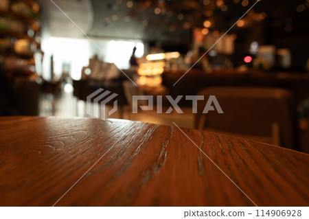 Empty wooden table top with lights bokeh on blur restaurant background Empty wooden table top with lights bokeh on blur restaurant background 114906928