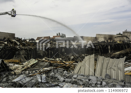Firefighter putting out a fire in Zellik, Belgium 114906972