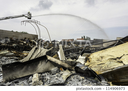 Firefighter putting out a fire in Zellik, Belgium Firefighter putting out a fire in Zellik, Belgium 114906973