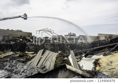 Firefighter putting out a fire in Zellik, Belgium Firefighter putting out a fire in Zellik, Belgium 114906976