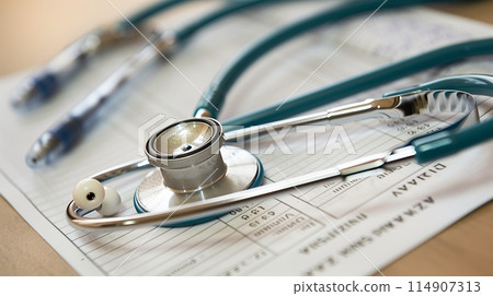 Health insurance card with a bill and stethoscope, key for covering medical costs. 114907313
