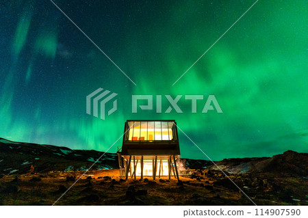 Aurora borealis, Northern lights glowing over luxury hotel on volcanic wilderness in winter at Iceland Aurora borealis, Northern lights glowing over luxury hotel on volcanic wilderness in winter at Iceland 114907590