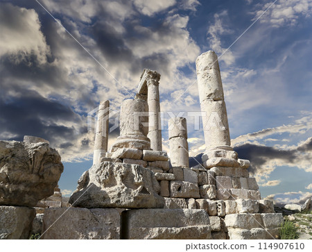 Amman city landmarks-- old roman Citadel Hill, Jordan. Against the background of a beautiful sky with clouds 114907610