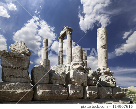 Amman city landmarks-- old roman Citadel Hill, Jordan. Against the background of a beautiful sky with clouds Amman city landmarks-- old roman Citadel Hill, Jordan. Against the background of a beautiful sky with clouds 114907616