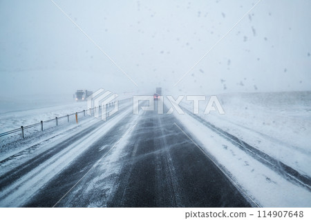 Car driving on snow covered highway road and blizzard with windy in countryside at Iceland Car driving on snow covered highway road and blizzard with windy in countryside at Iceland 114907648