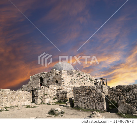 Amman city landmarks-- old roman Citadel Hill, Jordan. Against the background of a beautiful sky with clouds Amman city landmarks-- old roman Citadel Hill, Jordan. Against the background of a beautiful sky with clouds 114907678