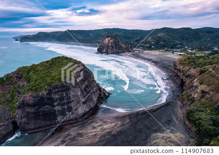 Beautiful iconic Lion Rock and breaking wave on Piha beach in the evening at Auckland, New Zealand Beautiful iconic Lion Rock and breaking wave on Piha beach in the evening at Auckland, New Zealand 114907683
