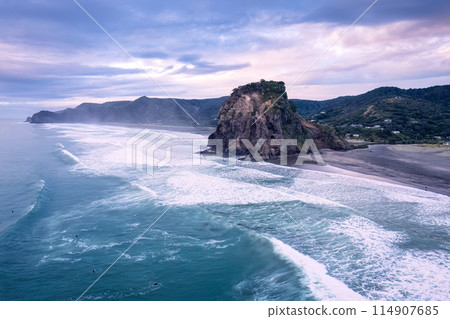Beautiful iconic Lion Rock and breaking wave on Piha beach in the evening at Auckland, New Zealand Beautiful iconic Lion Rock and breaking wave on Piha beach in the evening at Auckland, New Zealand 114907685