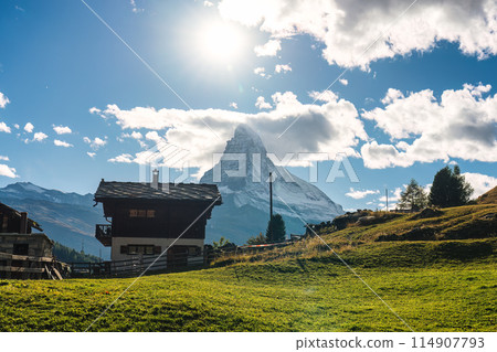 Peaceful farming village on hill with matterhorn mountain in rural scene at Switzerland Peaceful farming village on hill with matterhorn mountain in rural scene at Switzerland 114907793