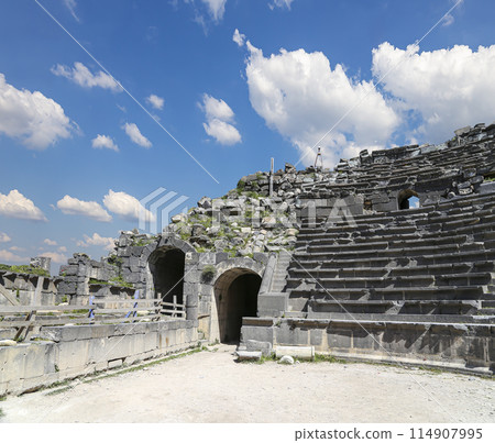 West Theatre of Umm Qais (Umm Qays)--is a town in northern Jordan near the site of the ancient town of Gadara, Jordan. Against the background of a beautiful sky with clouds 114907995