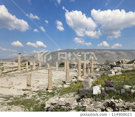 Roman ruins at Umm Qais (Umm Qays)--is a town in northern Jordan near the site of the ancient town of Gadara, Jordan. Against the background of a beautiful sky with clouds 114908023