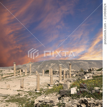 Roman ruins at Umm Qais (Umm Qays)--is a town in northern Jordan near the site of the ancient town of Gadara, Jordan. Against the background of a beautiful sky with clouds 114908024