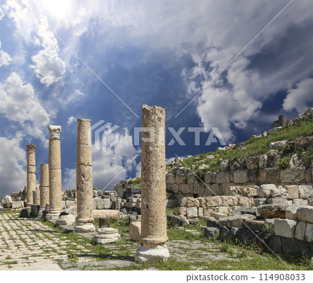 Roman ruins at Umm Qais (Umm Qays)--is a town in northern Jordan near the site of the ancient town of Gadara, Jordan. Against the background of a beautiful sky with clouds 114908033