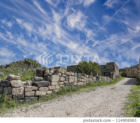 Roman ruins at Umm Qais (Umm Qays)--is a town in northern Jordan near the site of the ancient town of Gadara, Jordan. Against the background of a beautiful sky with clouds 114908065