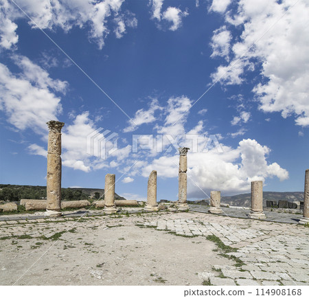 Roman ruins at Umm Qais (Umm Qays)--is a town in northern Jordan near the site of the ancient town of Gadara, Jordan. Against the background of a beautiful sky with clouds 114908168
