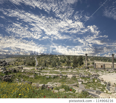 Roman ruins at Umm Qais (Umm Qays)--is a town in northern Jordan near the site of the ancient town of Gadara, Jordan. Against the background of a beautiful sky with clouds 114908216
