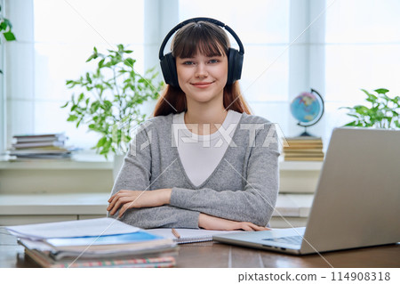 Portrait of teenage college student wearing headphones Portrait of teenage college student wearing headphones 114908318