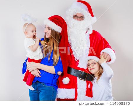 Mother, Santa and two daughters christmas family photo 114908370