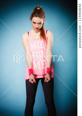 teen crime - teenager girl in handcuffs teen crime - teenager girl in handcuffs 114908648