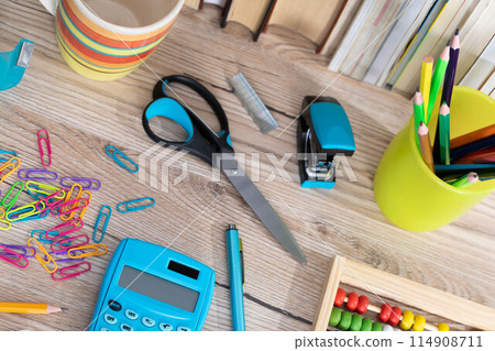 Office accessories necessary for learning. The paper clips are on the desk. School materials. Office accessories necessary for learning. The paper clips are on the desk. School materials. 114908711