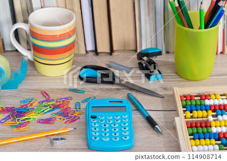 Office accessories necessary for learning. The paper clips are on the desk. School materials. Office accessories necessary for learning. The paper clips are on the desk. School materials. 114908714