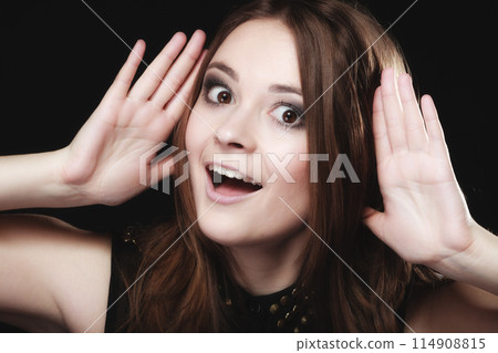 Gossip. Young woman with hands to ear listening Gossip. Young woman with hands to ear listening 114908815