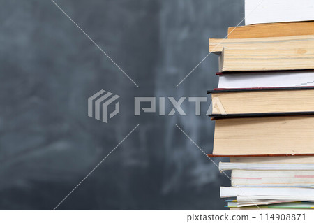 School readings arranged in a row at the front and in the background there is a school board not properly washed. School readings arranged in a row at the front and in the background there is a school board not properly washed. 114908871