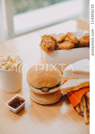 Closeup of home made burgers on wooden background Closeup of home made burgers on wooden background 114909230