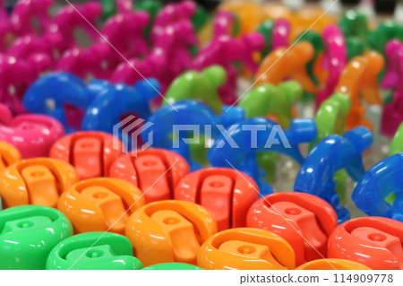 Multicolored bottle caps, selective focus, bright colorful background. Multicolored bottle caps, selective focus, bright colorful background. 114909778
