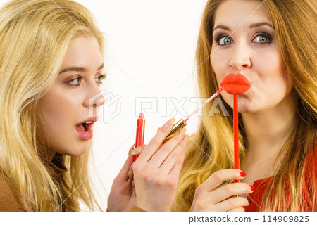 Two women and lip product Two women and lip product 114909825