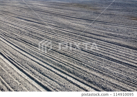 Plowed agricultural field, aerial view. Agricultural land. Background. 114910095