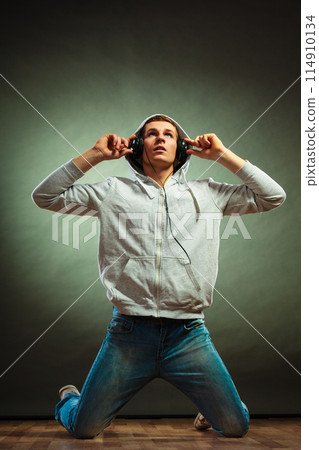 handsome man with headphones listening to music handsome man with headphones listening to music 114910134